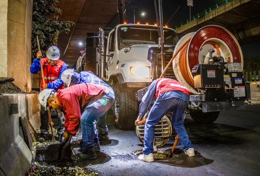 Workers cleaning a drainage line